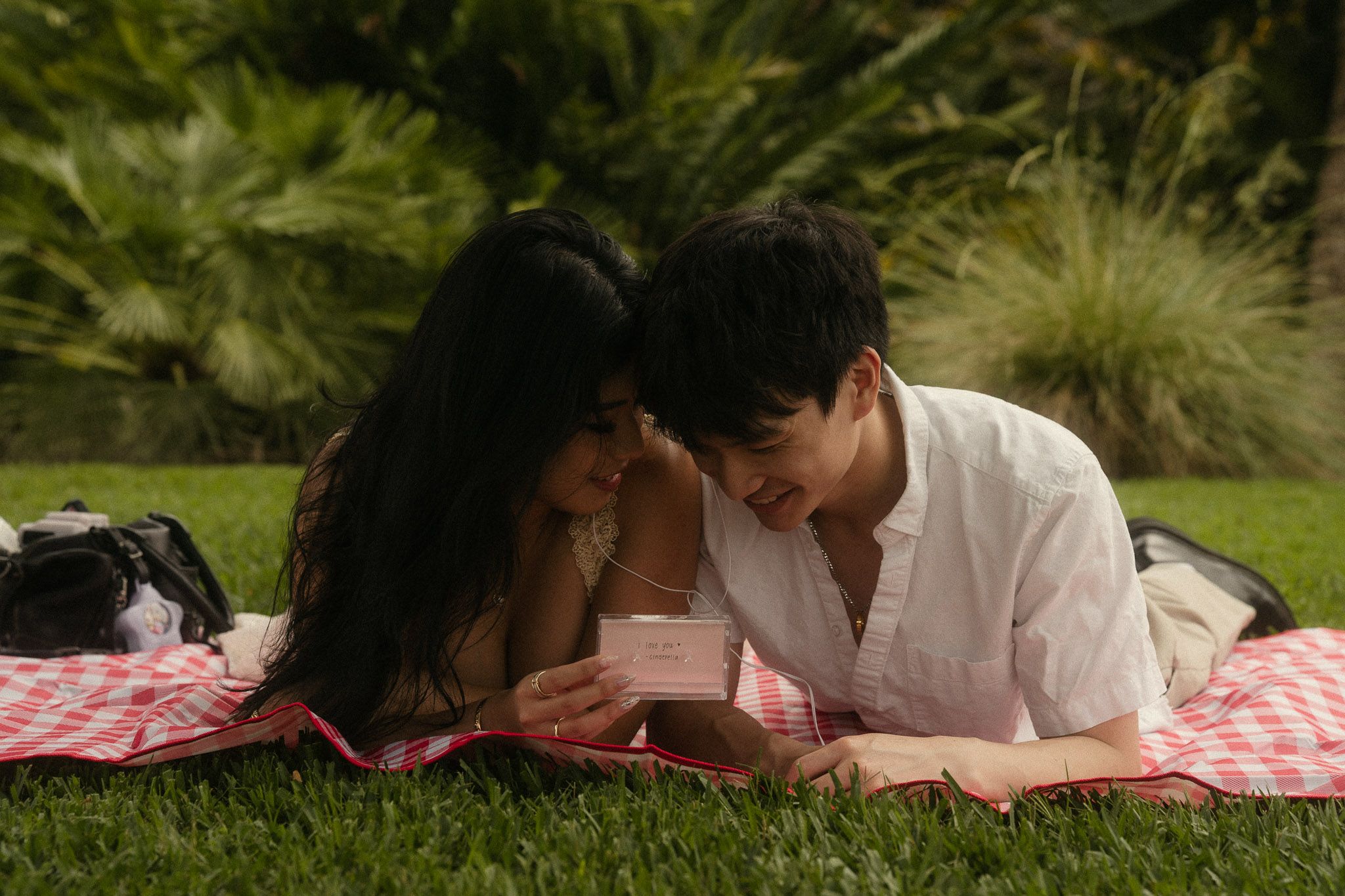 Cindy and Brandon listening to a cassette together during their engagement photos at the Huntington Library in San Marino.