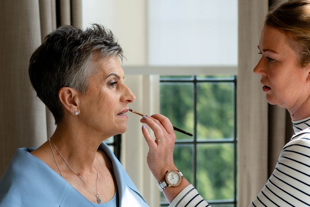 Final touches of lipstick to Bride on her Wedding day at Bovey Castle, Dartmoor