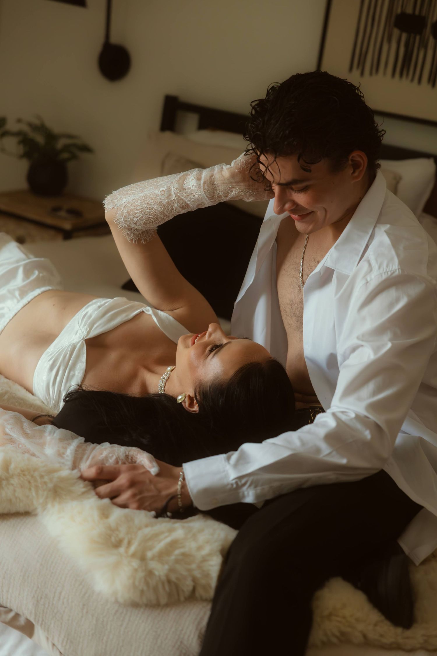 A romantic couple shares an intimate moment on a bed during their Ojai elopement.