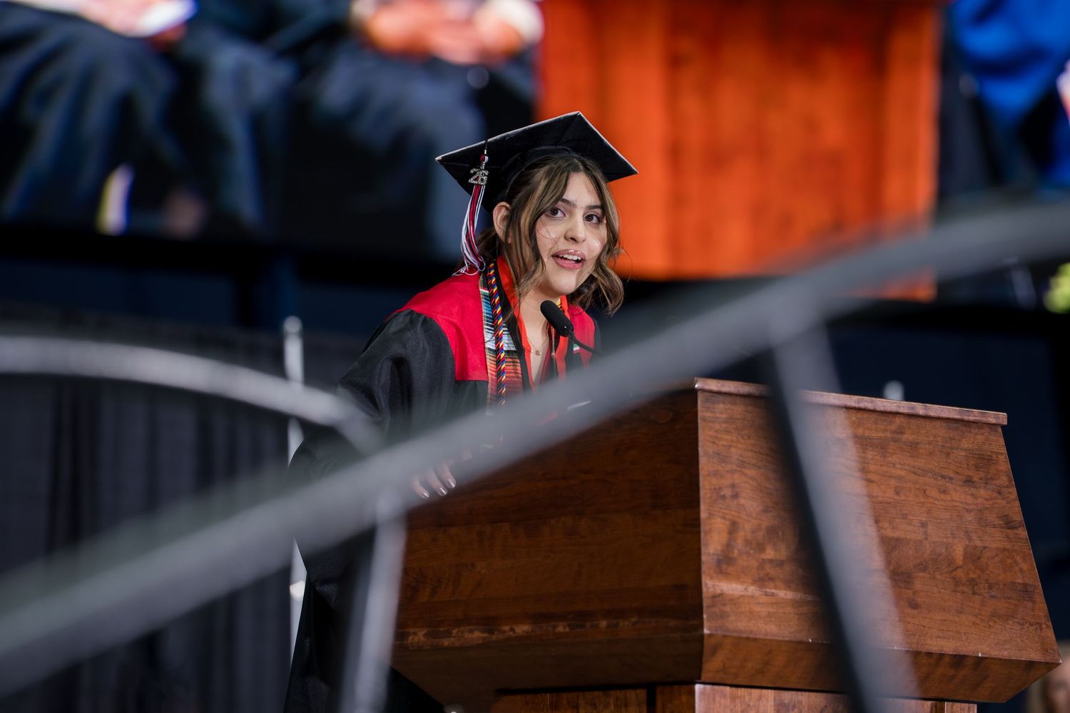 Aranxa Resendez, standing at a podium, welcomed the 2025 CHS Graduation crowd in Spanish..