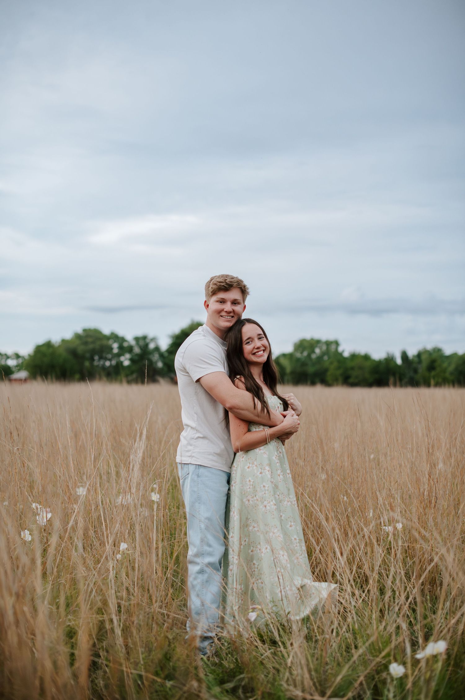 Wichita KS outdoor engagement photos in nature location Andover, couple photos in field with flowers, small elopement wedding photographer