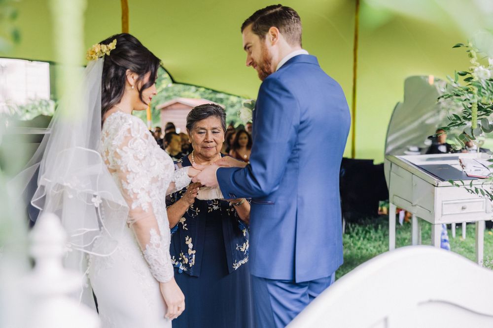 Bride and groom exchanging rings at an outdoor wedding ceremony..