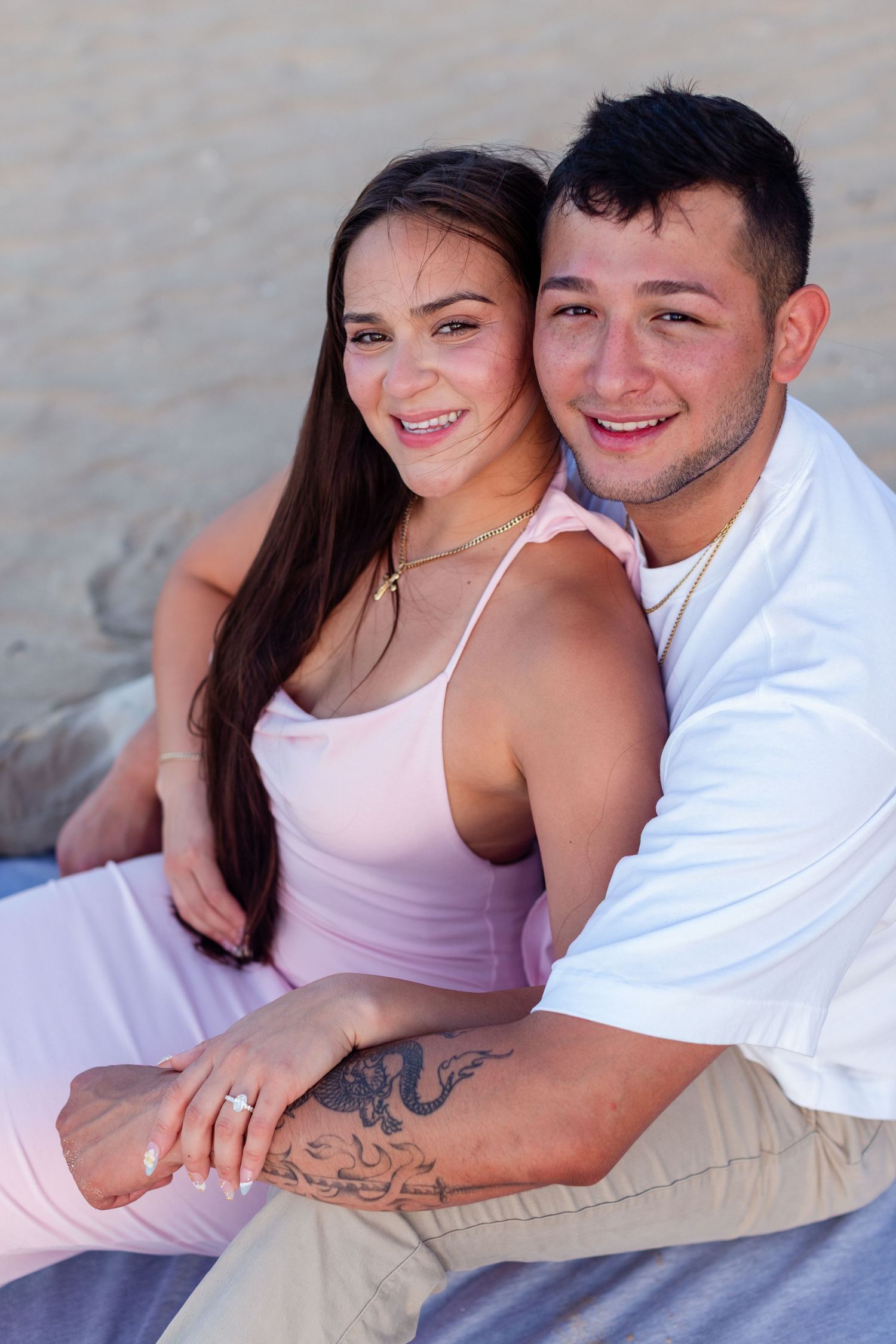 Couples portrait seated at the beach in Isla Verde, Carolina, Puerto Rico.