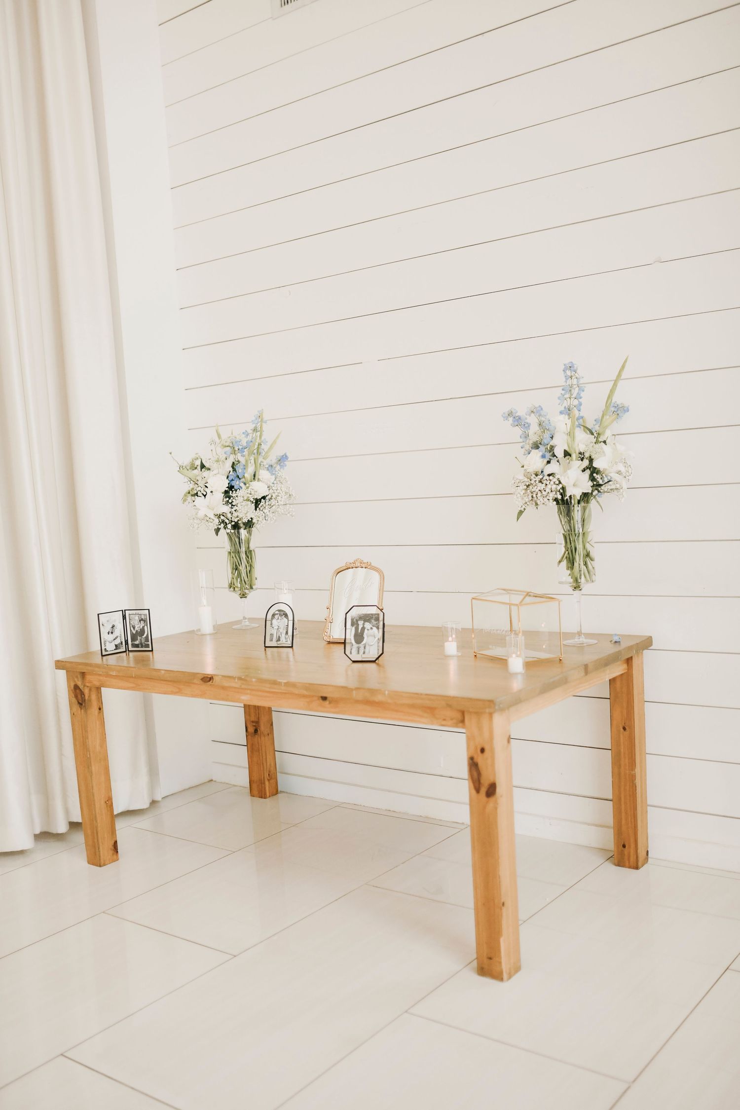 Reception tables with gold chargers black napkins and dust blue menus