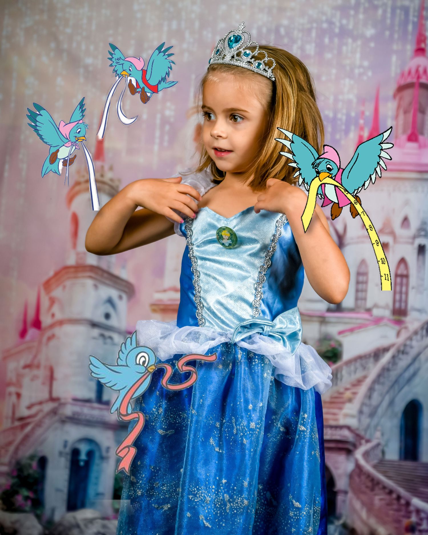 Young girl in blue Cinderella princess dress and tiara poses with animated cartoon birds in a fairy tale castle setting.