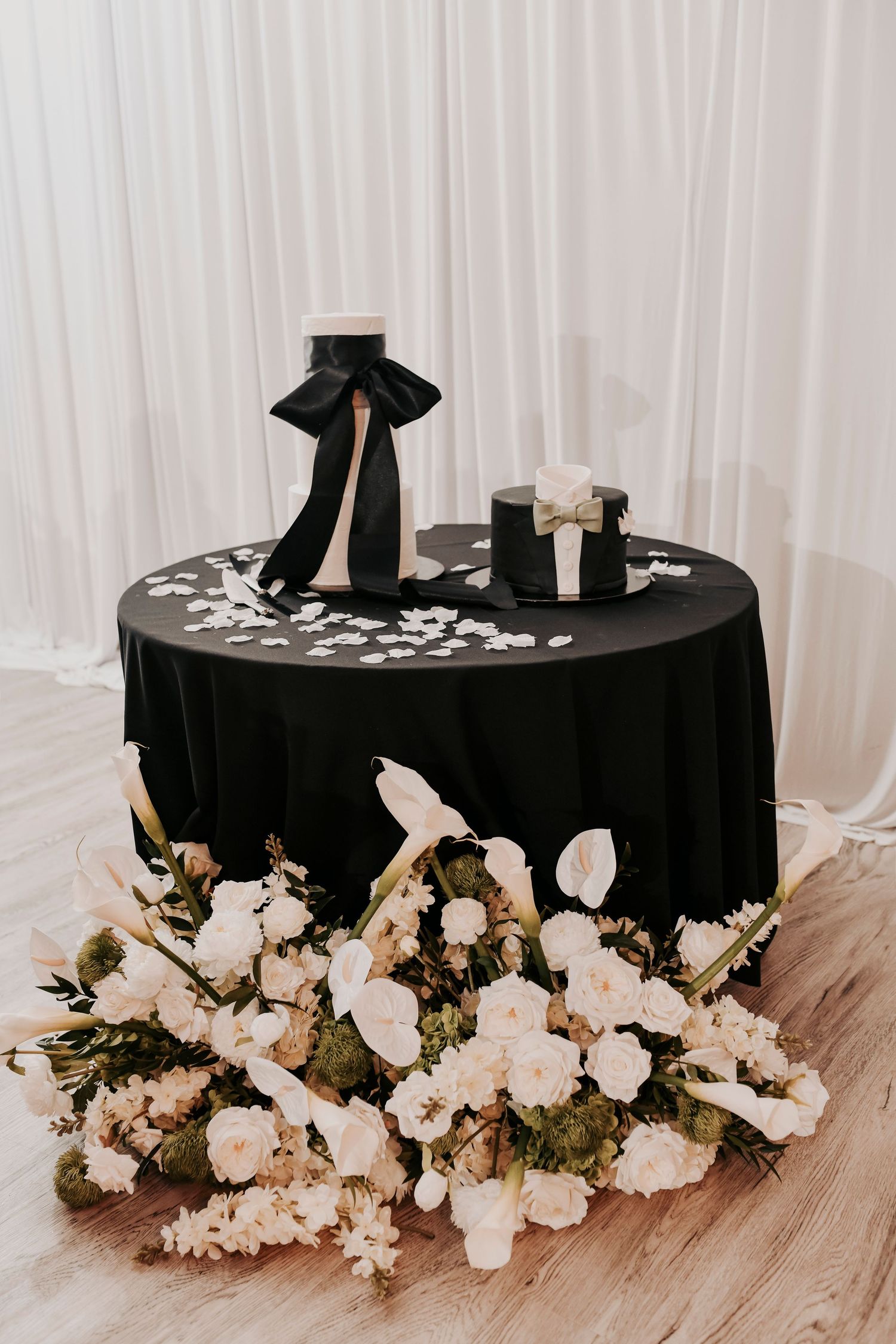 Wedding cake display featuring elegant black and ivory details