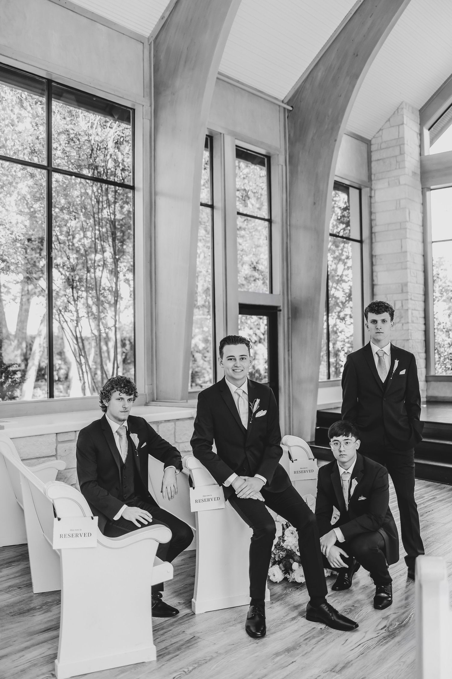 Elegant groom portrait in Brighton Abbey's naturally lit chapel