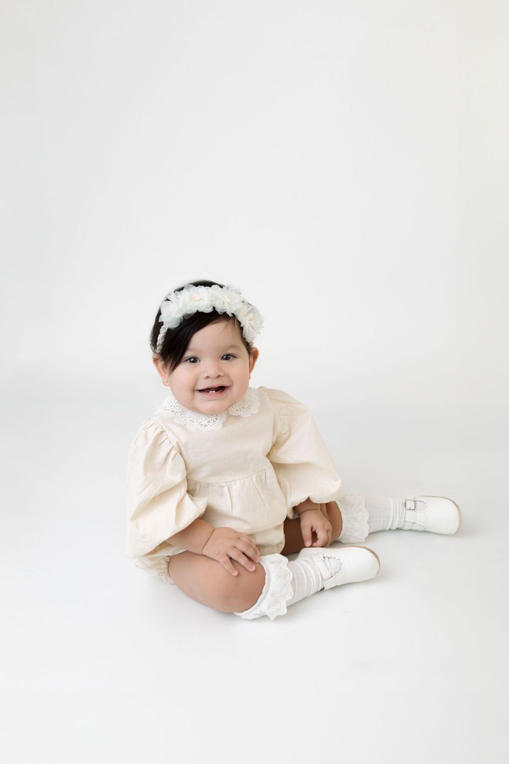 Studio portrait in cream-colored vintage outfit.
