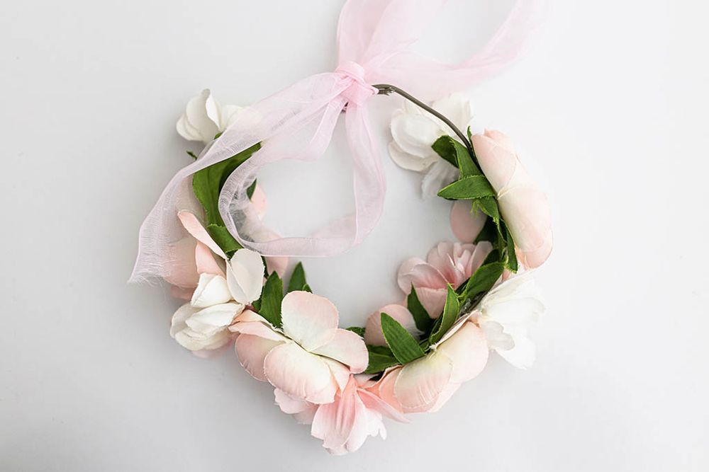 Delicate pink and white floral crown with pink ribbon bow for baby girls photoshoot near Canyon Lake CA.