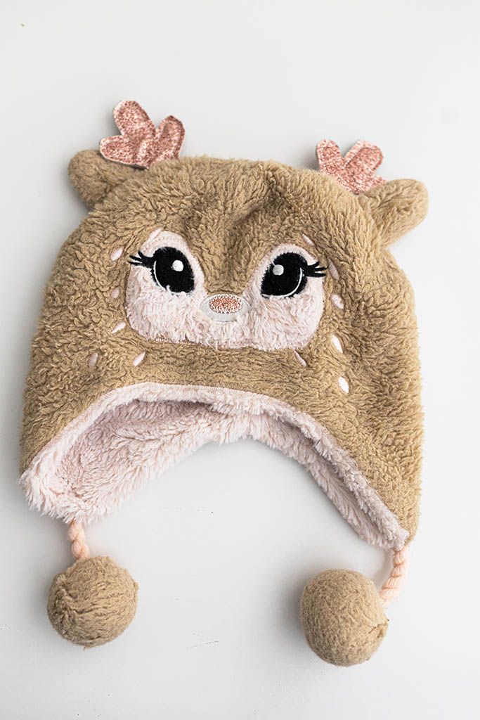 Baby girl's brown fuzzy deer animal hat with pom poms.