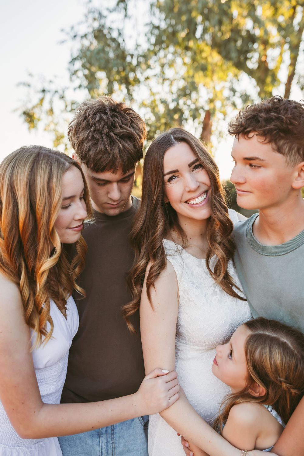 A group of five young people smiling and embracing outdoors with heidi grace photography