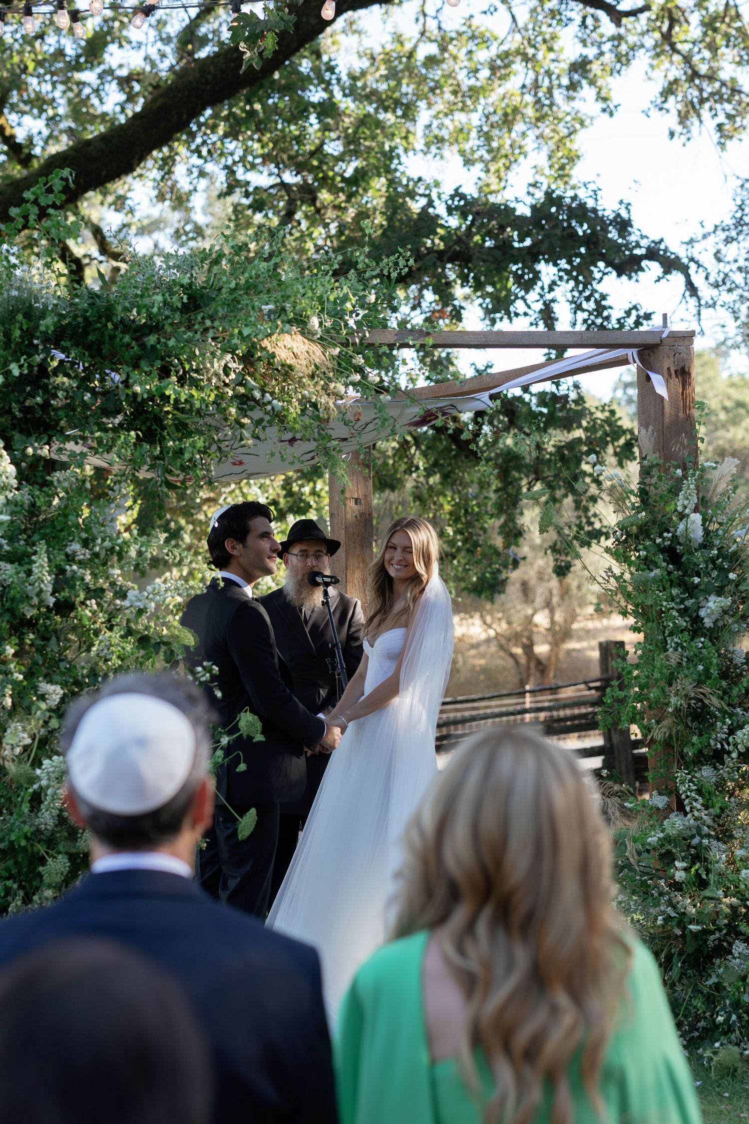 A white wedding dress shows a dramatic ombre effect transitioning from pristine white to smoky grey at the bottom.