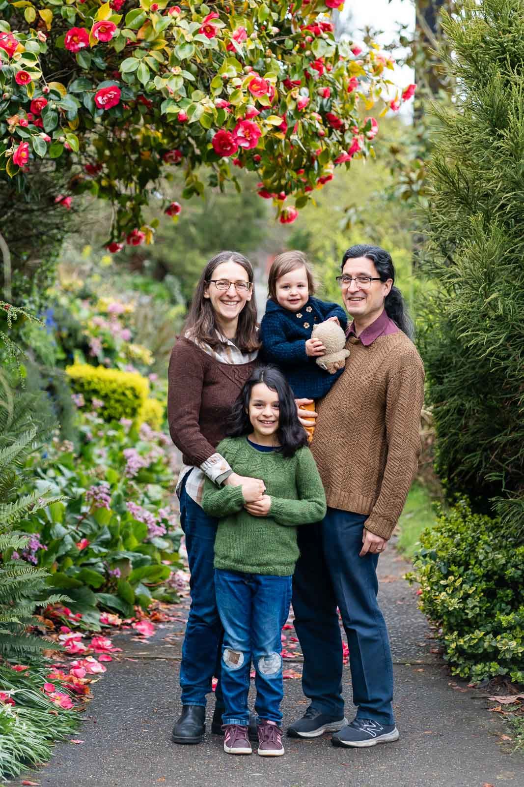Posed family portrait amongst a flowering neighborhood street.