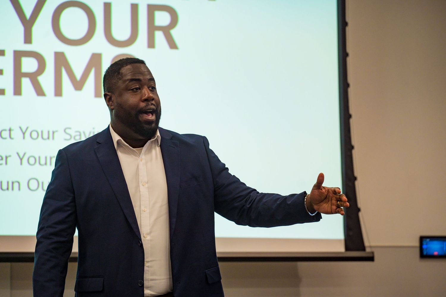 Engaging male speaker presents Retirement On Your Terms financial seminar to an audience.