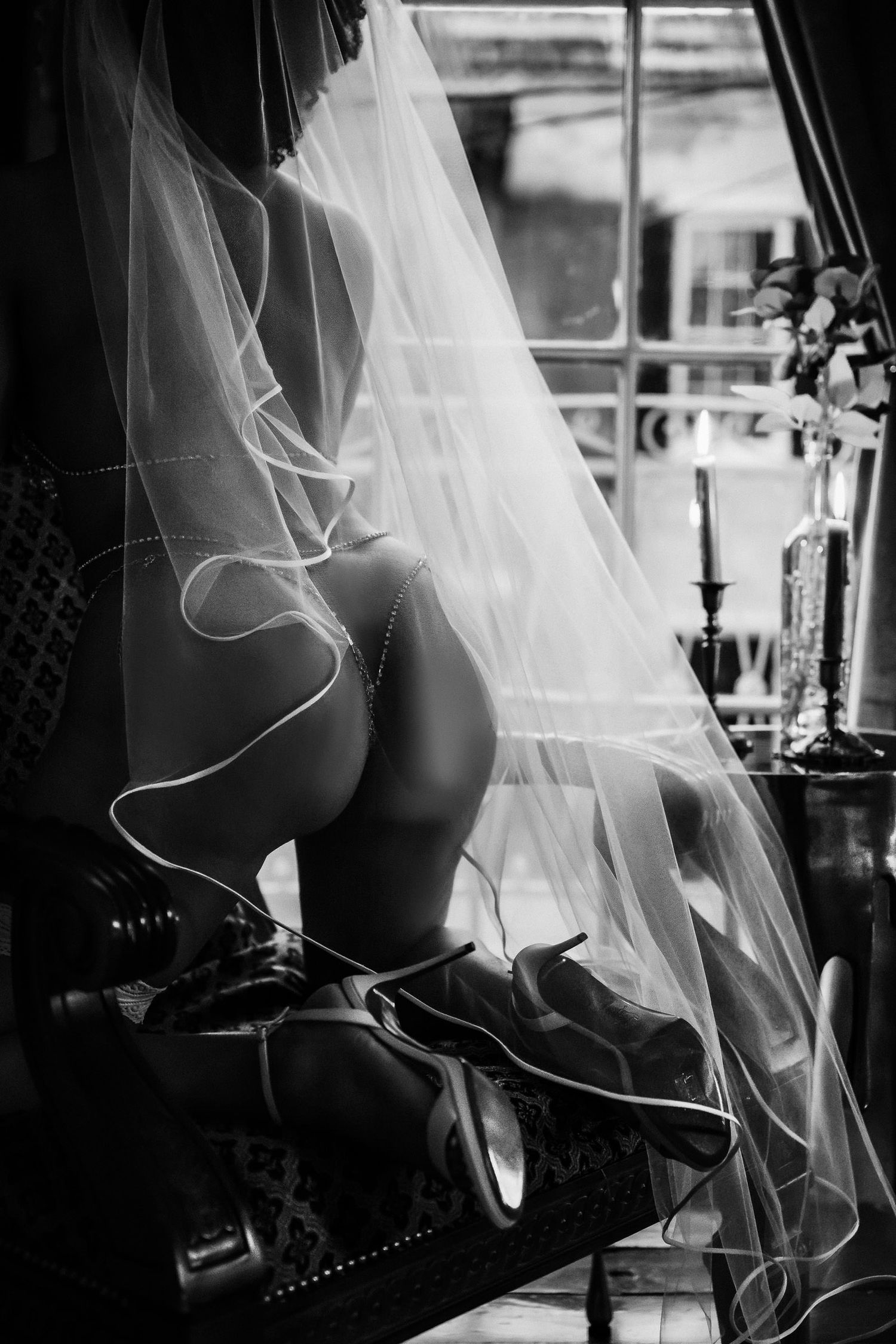 Black and white photo of a bride in heels under a veil, elegant boudoir wedding photography. boudoir gift for husband wedding