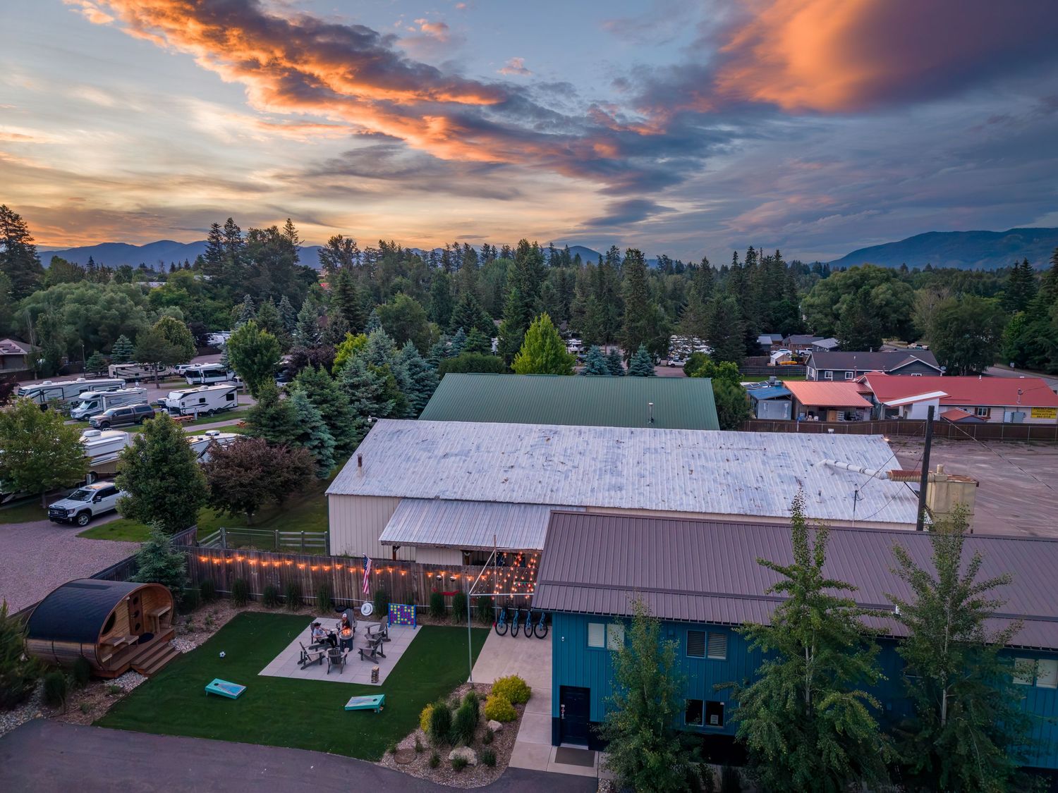 Aerial/drone shot of the micro resort, Cabins at Urban Woods at sunset in Columbia Falls, MT.