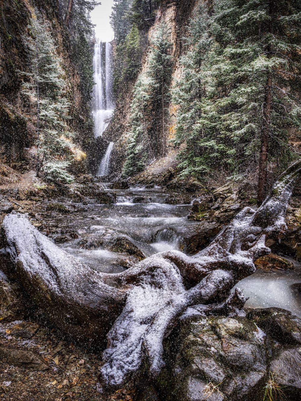 Snowy shot of a waterfall and river by Denver Hospitality, Travel & Tourism photographer Captain Colorado Photography.