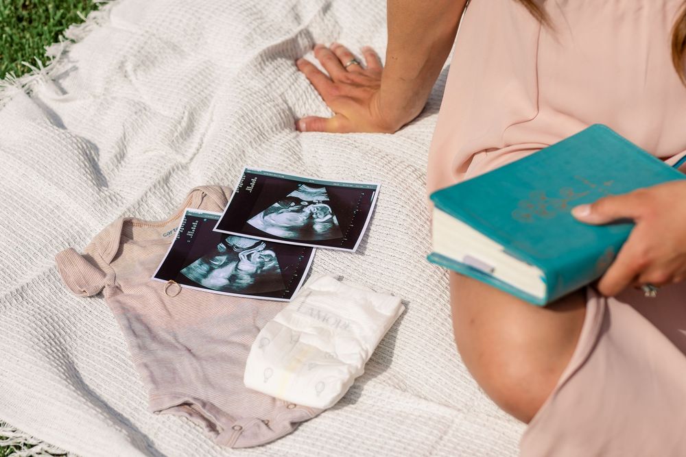 Expecting mother of three embracing her final pregnancy in a peaceful outdoor setting