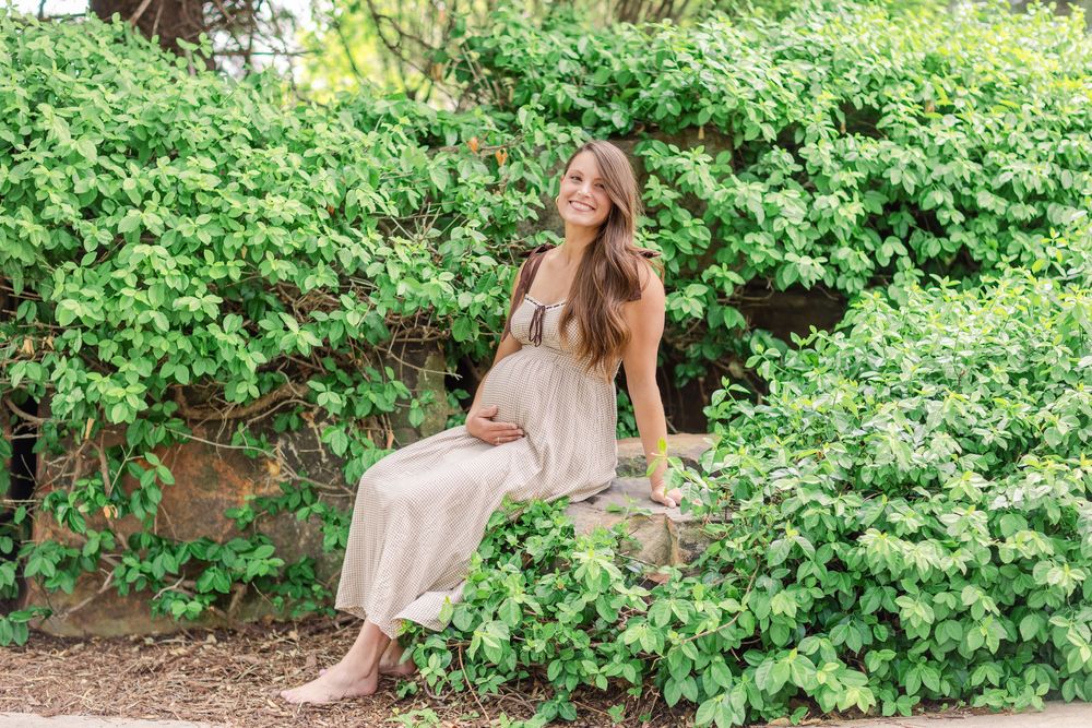 Golden light filtering through trees during a spring maternity session in Wichita