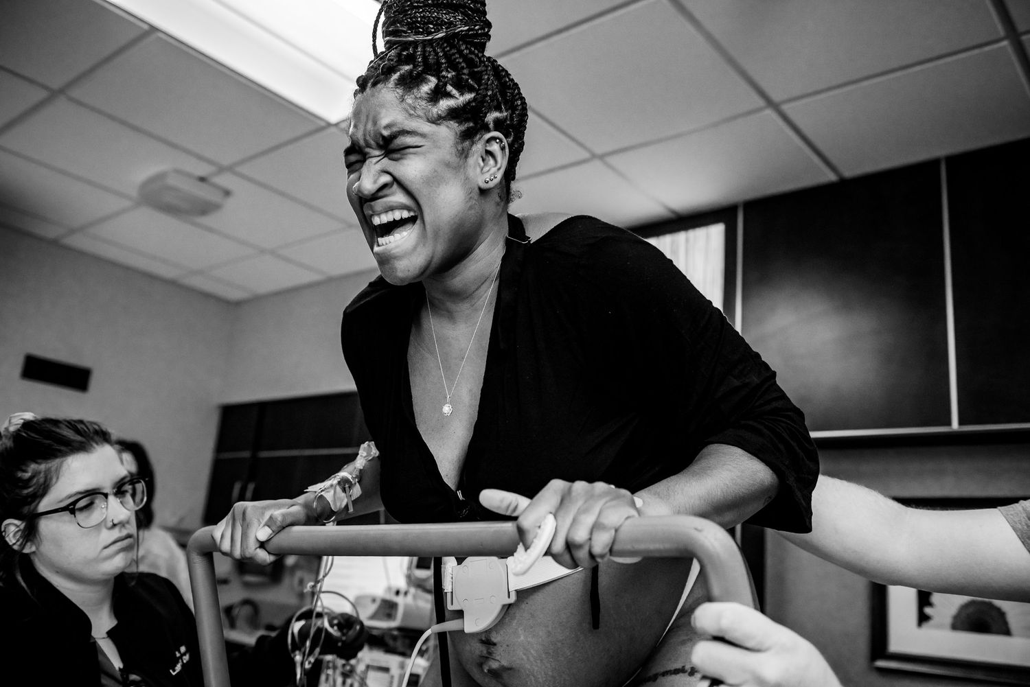 Black and white photo showing people laughing and enjoying themselves in what appears to be an office setting.