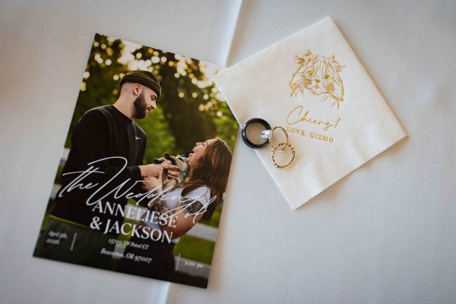 Wedding flat lay featuring a program for Annelese and Jackson beside gold rings on a personalized napkin.