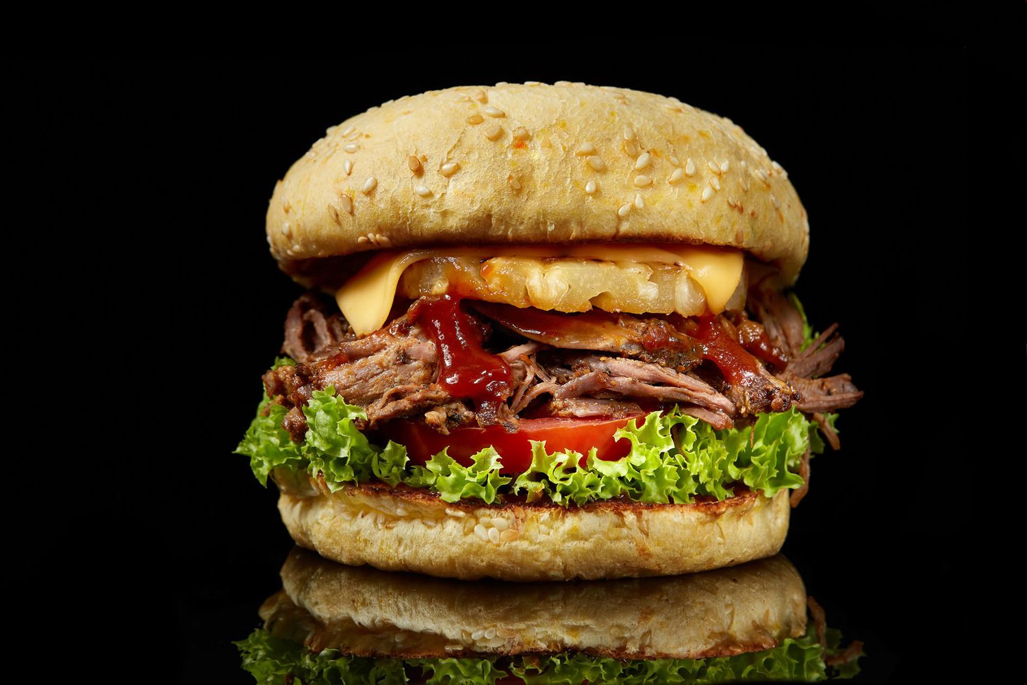 Gourmet pulled pork burger on a black background, food photography by RezinMedia in Calgary