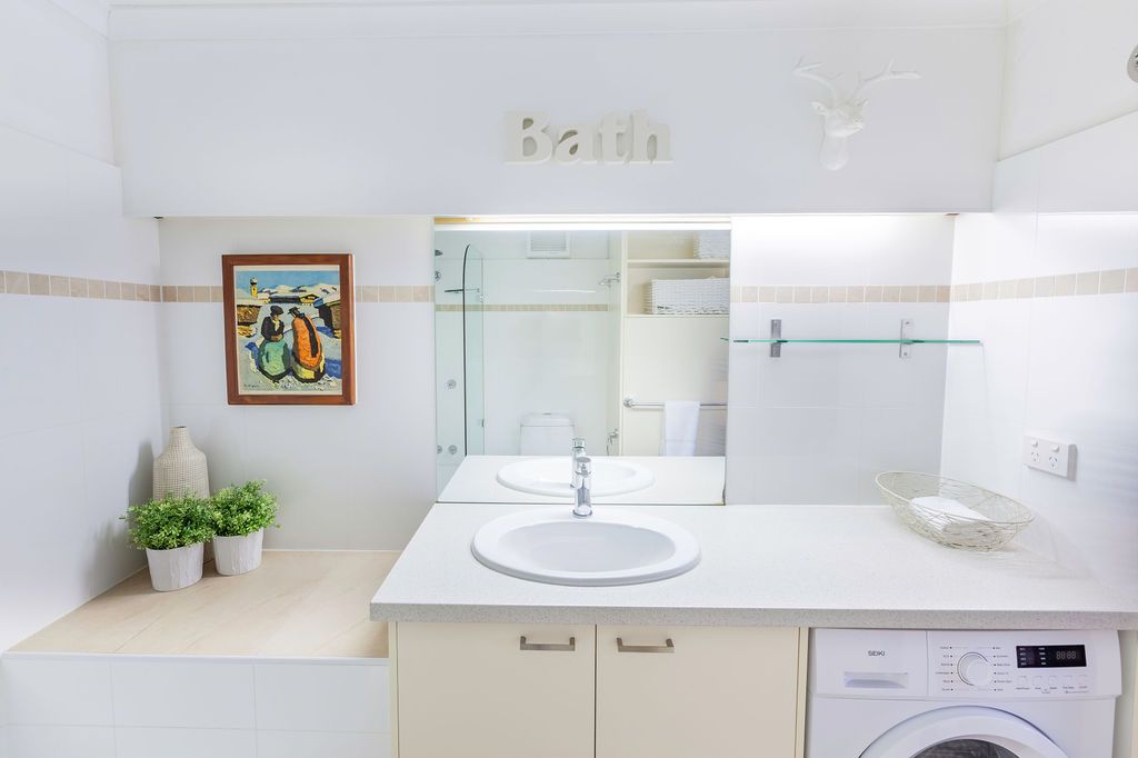 Bright white modern bathroom interior with sleek fixtures and minimalist design features.
