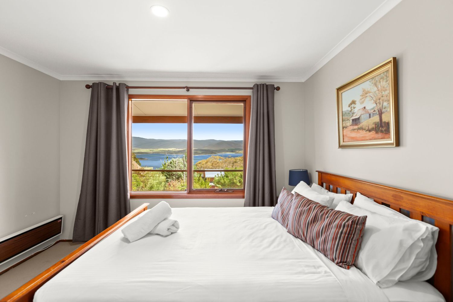 A collage of modern bedroom interiors with white walls, wooden furniture, and scenic window views.