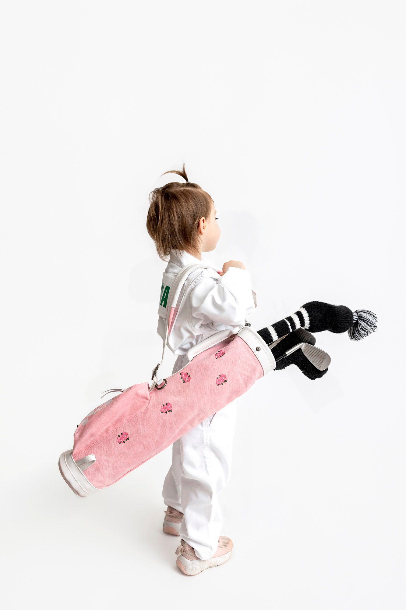 A series of dynamic action shots showing a person in white practicing martial arts moves with a pink bag.