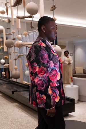 Amir Johnson wears A floral blazer with vibrant pink and red roses during the2026 North Carolina Azalea Festival Spring Fashion Show