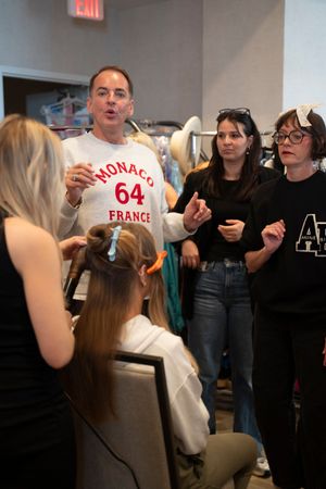 A guest of people stand together, preparing behind the scenes for the2026 Azalea Festival Spring Fashion Show