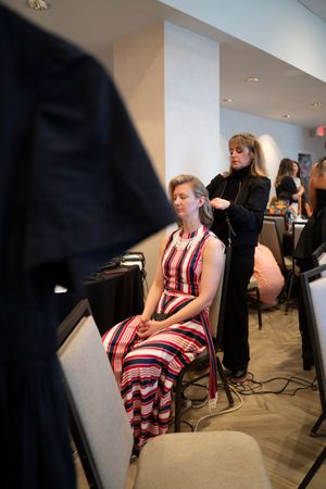Behind the scenes at a salon where a guest is getting prepared for the 2026 North Carolina Azalea Festival Spring Fashion Show