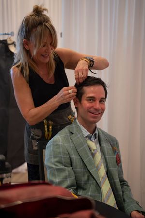 Hair sylist preparing a guest behind the scenes at the Azalea fashion show 2026