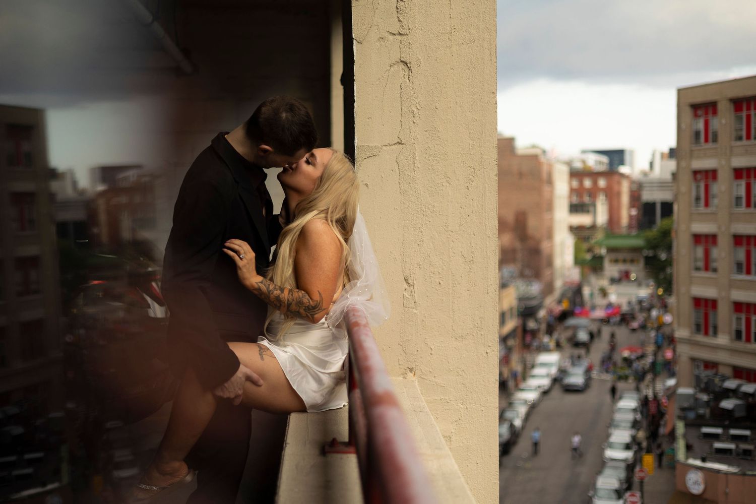 A couple kisses in a parking garage after their elopement in the heart of Boston's Chinatown district.