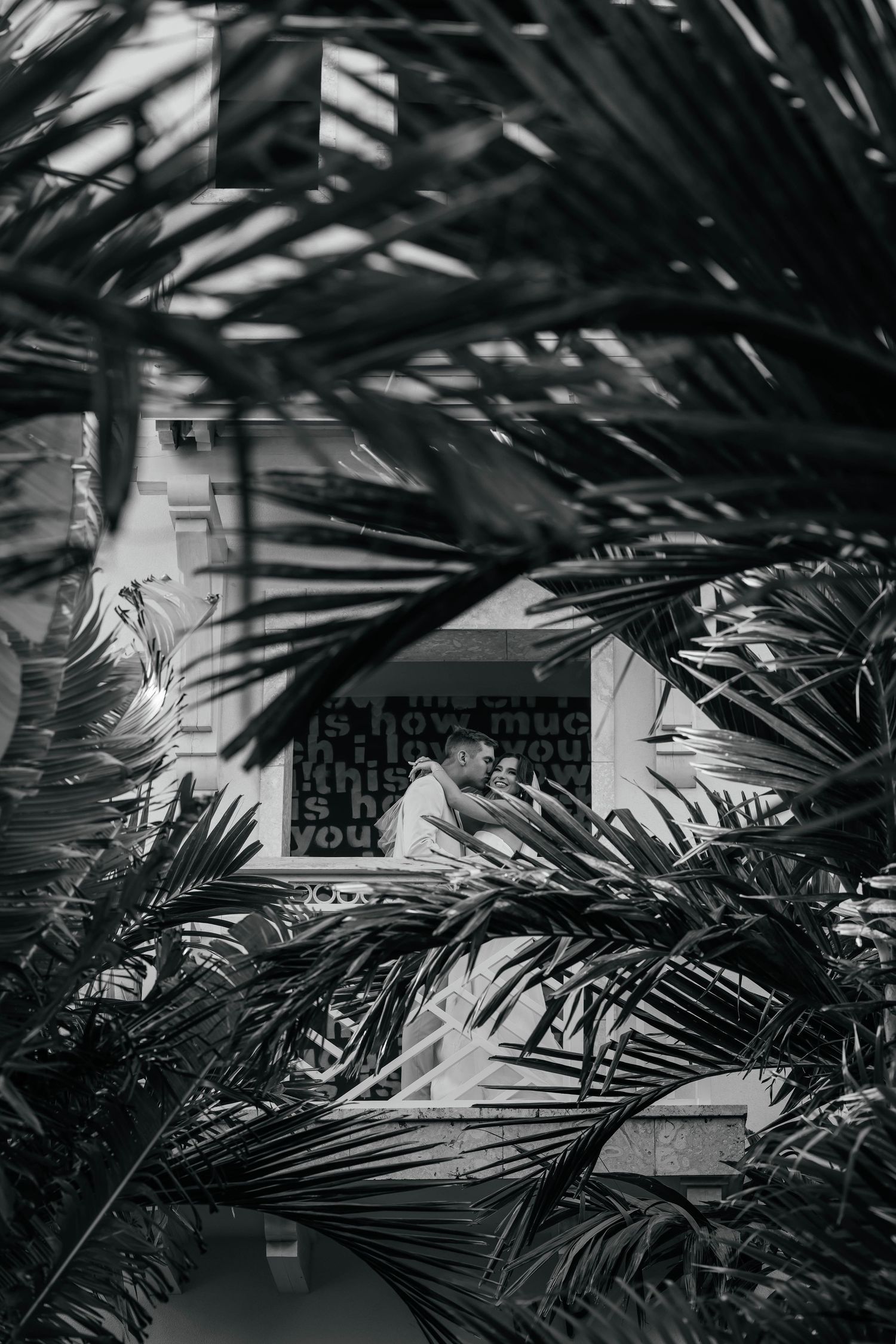 A romantic seaside wedding photoshoot with a flowing white veil catching the ocean breeze.