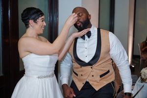 Couple embraces on the dance floor during their wedding celebration in a modern venue.