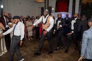 Wedding guests dance and celebrate on the dance floor during a lively reception.