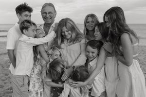 A group of people share joyful moments together on the beach in black and white photography.