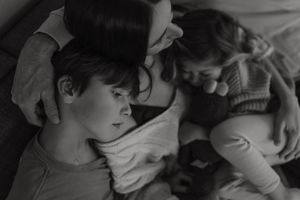 A series of black and white photographs showing tender moments between parent and child arranged in a horizontal strip.