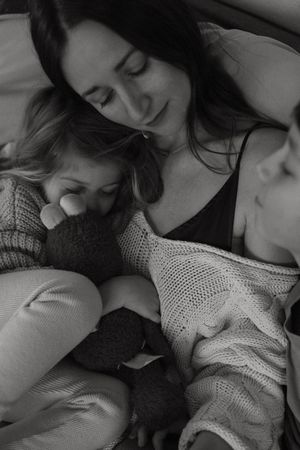Black and white intimate photographs showing tender moments between two people in cozy sweaters.