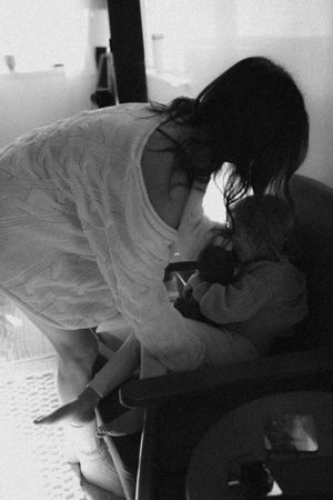 Black and white sequence showing movement and interaction on a dark couch.