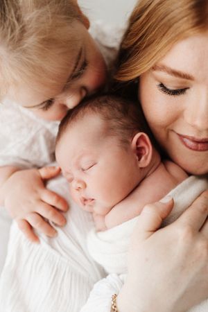 Intimate series of soft close-up portraits showing tender family cuddles.