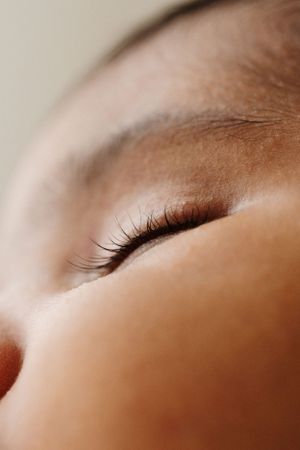 Extreme close-up shots showing delicate eyelashes and peaceful sleeping features.
