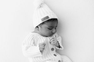 Three black and white images of a sleeping baby showing peaceful expressions.