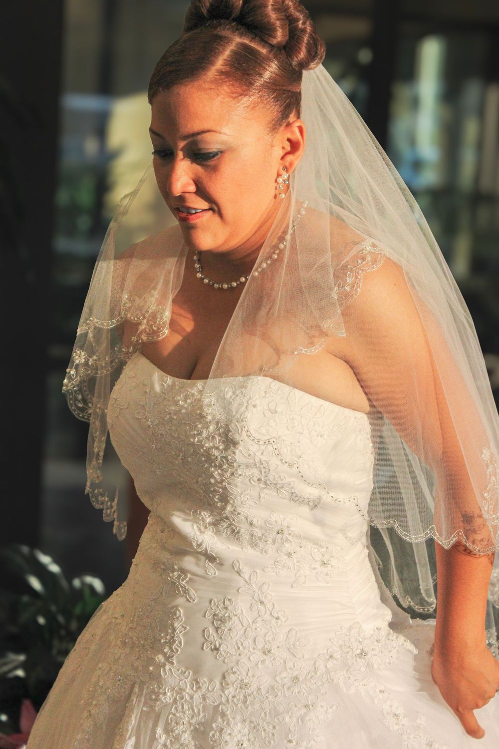 A series of bridal portraits showing details of a white wedding gown and veil in an indoor setting.