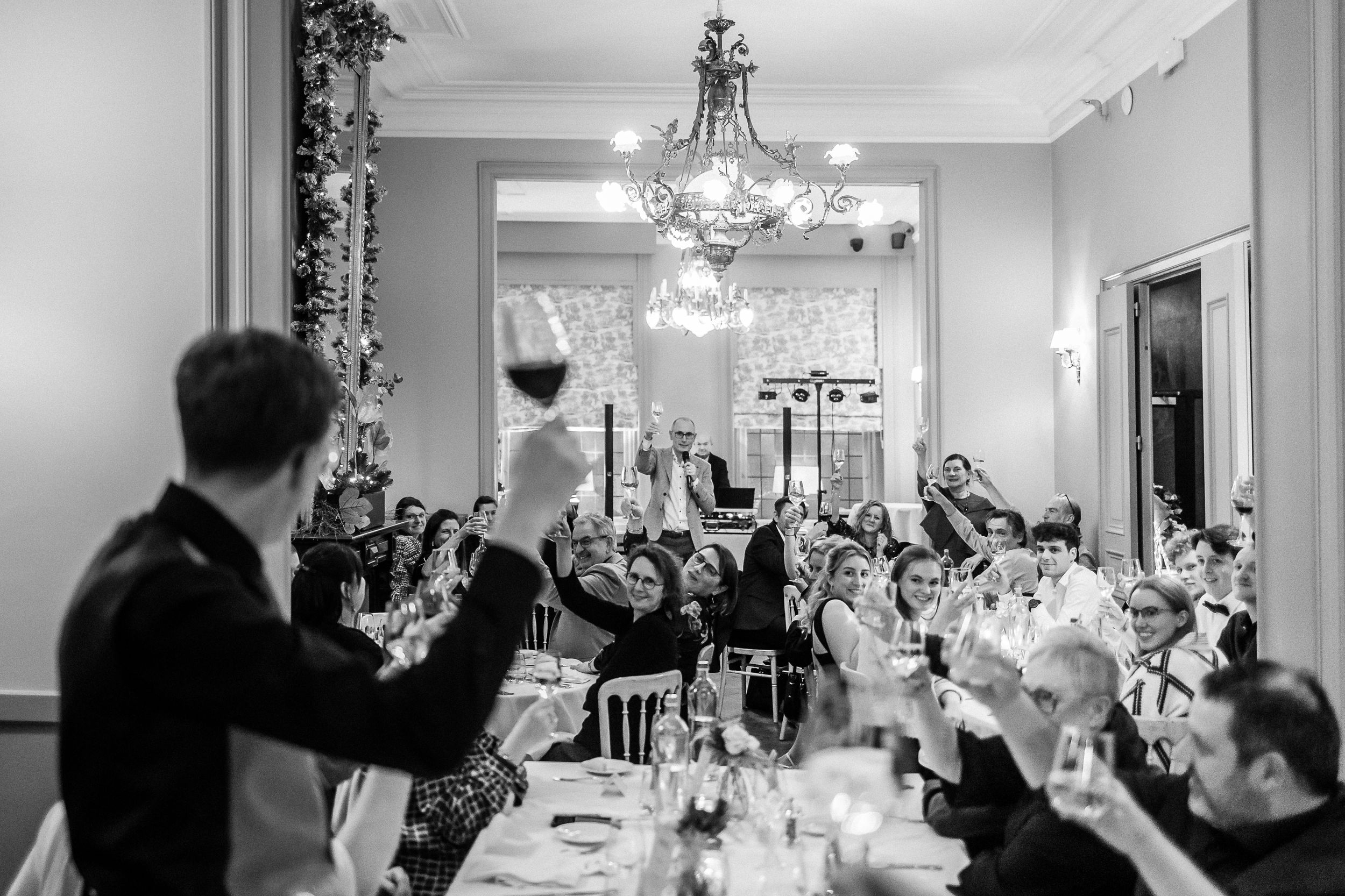 Candid moments captured between guests during an evening wedding celebration.