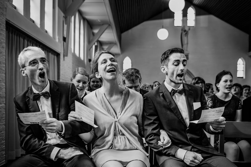 Black and white candid photos showing people laughing and reacting during a group gathering.