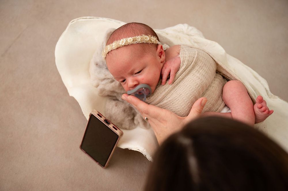 Collection of peaceful newborn photography poses on soft cream-colored blankets.