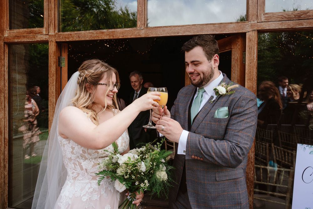 Bath Wedding Photographer Zara Davis Photography Cotswolds Wick Farm Bath first toast for happy couple