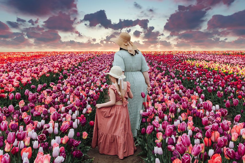 Mother and daughter walking through tulip field during photoshoot at The Tulip Barn, Netherlands, photographed by Jorietha Rabie Photography